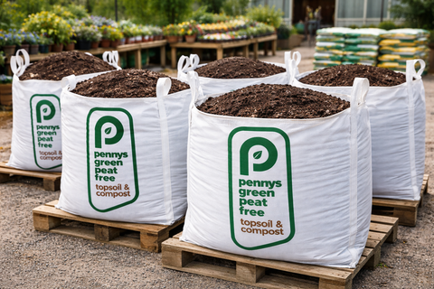 Bags of Pennys Green Peat Free Topsoil and Compost on pallets with a garden setting in the background.