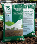 Two bags of Somerset Topsoil with a background of gardening supplies.